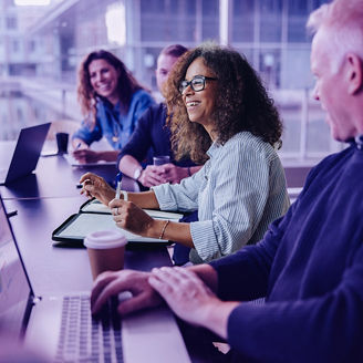 Multi-ethnic business people smiling during a meeting in conference room. Team of professionals having meeting in boardroom.; Shutterstock ID 1956492793; purchase_order: MarketingTEam Advisory Assurance; job: Anne Rouschop; client: SAP