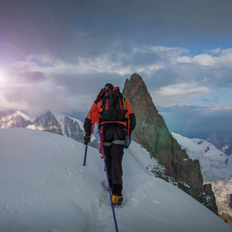 Caucasian climber admiring view from remote mountain top