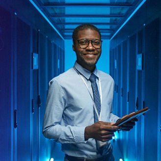 Man smiling while holding a tablet
