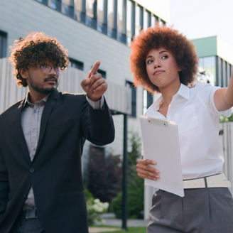 African American woman businesswoman showing building commercial property city skyscrapers company office urban to male client buyer investor walking Indian man Arabian businessman business discuss. High quality 4k footage