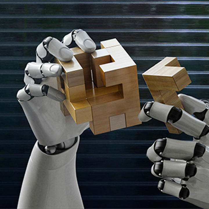 Robot hands solving wooden puzzle banner
