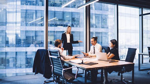 Professional financial experts collaborating during brainstorming meeting listening information from clever female director, businesswoman providing information to corporate workers of company