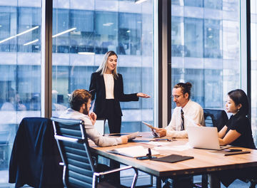Professional financial experts collaborating during brainstorming meeting listening information from clever female director, businesswoman providing information to corporate workers of company