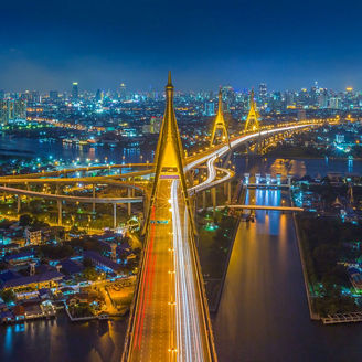 Skyline of Bangkok, showing a river, bridges and highways