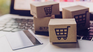 Online shopping - Paper cartons or parcel with a shopping cart logo and credit card on a laptop keyboard. Shopping service on The online web and offers home delivery.