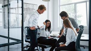 With documents. Young business people in formal clothes working in the office.