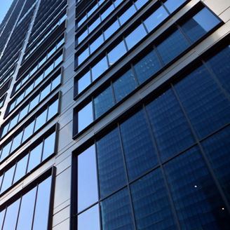 Concept for real estate and corporate construction..The modern office building of the orange morning sun in the sky background.