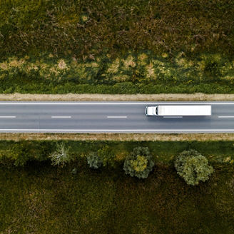 Large freight transporter semi-truck on the road, aerial view top down from drone pov