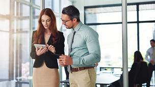 Business talk at its best. Shot of colleagues using a tablet in a modern office.