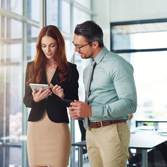 Business talk at its best. Shot of colleagues using a tablet in a modern office.