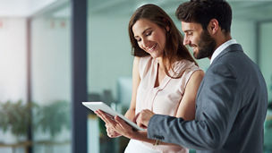 Positivity inspires productivity. Shot of a young businessman and businesswoman using a digital tablet together in an office.
