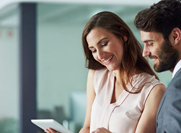 Positivity inspires productivity. Shot of a young businessman and businesswoman using a digital tablet together in an office.