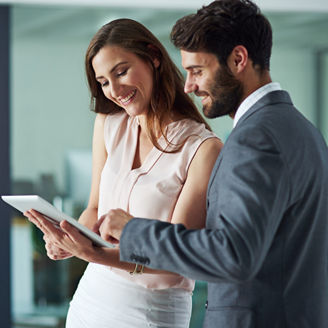 Positivity inspires productivity. Shot of a young businessman and businesswoman using a digital tablet together in an office.