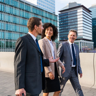 Multiracial group of business people bonding outdoors - International business corporate team wearing elegant suit meeting in a business park
