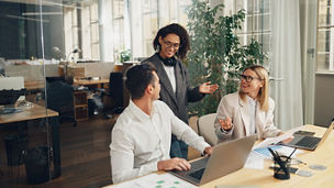 Group of business colleagues working together on project in modern coworking. Teamwork concept