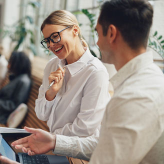 Woman office worker discussing new project with colleague during working day in coworking