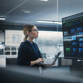 Portrait of a Multiethnic QA Engineer Working on Finding and Fixing Bugs in a Product or Program Software Code Before the Launch. Female Using Laptop Computer, Collaborating with Developers Online