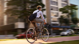 Fast, bicycle and business man in city for morning, commute and carbon neutral transportation. Travel, sustainability and cycling with male employee in urban town for motion blur, speed and transit