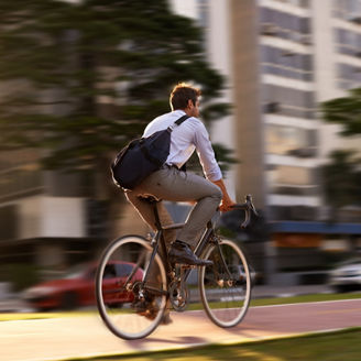 Fast, bicycle and business man in city for morning, commute and carbon neutral transportation. Travel, sustainability and cycling with male employee in urban town for motion blur, speed and transit
