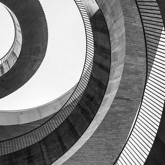 Geometric abstraction in the form of chaotic semicircles and arcs of different textures and from different materials. Black and white photo