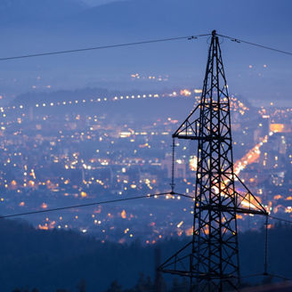 High power electricity poles in urban area. Energy supply, distribution of energy, transmitting energy, energy transmission, high voltage supply concept photo.