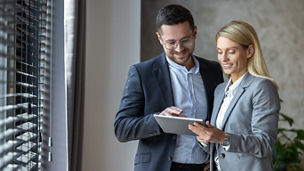 Business people enjoying work together using tablet for online project discussing