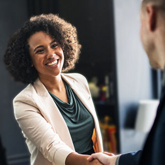 Business partners shaking hands in agreement. Business agreement with a handshake. Woman shaking hands with business owner. Ceo in handshake with new employee. Business deal sealed with a handshake.