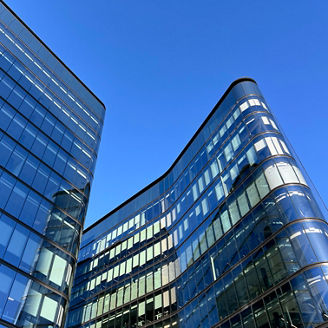 Modern glass office buildings with contrasting shapes
