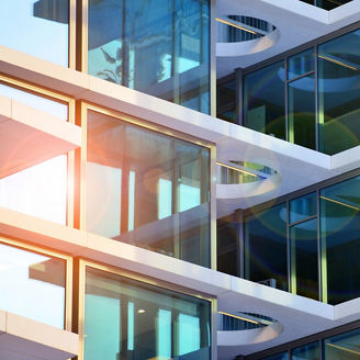 Modern office building exterior made from glass and steel. Windows of office building. Abstract architectural concept with sunlight.