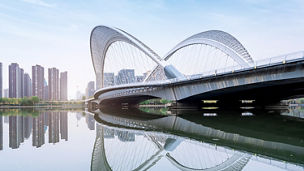 Skyline against a river and a bridge