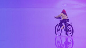 Small girl riding bicycle on beach