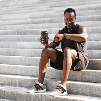 Smiling man looking at smartwatch