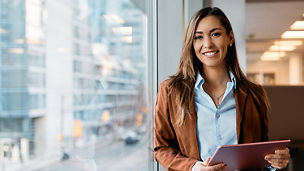 Smiling woman holding tablet