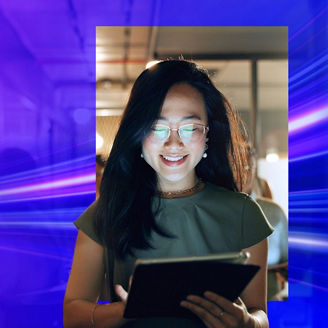 Smiling woman in spectacles looking at ipad