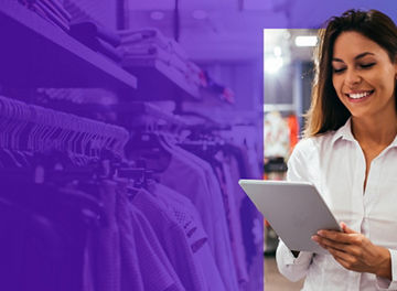 Smiling woman on tablet in clothing store