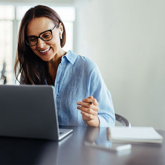 Smiling woman working on laptop