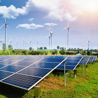 Solar panel with wind turbines against mountains and sky as background - image