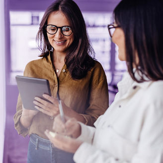 Business women standing next to a window and discussing their ideas. Female business professionals brainstorming using stocky notes and a tablet.; Shutterstock ID 2400306923; purchase_order: marketing advisory assurance; job: Anne; client: AI campagne