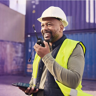 Construction worker holding walkie talkie