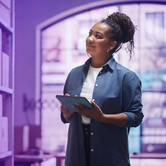 Woman looking sideways while holiding tablet
