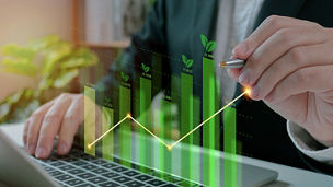 Businessman use laptop analyzing sustainability company growth with digital virtual graphics, financial data for long term investment.