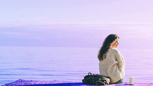 Woman sitting in front of the sea