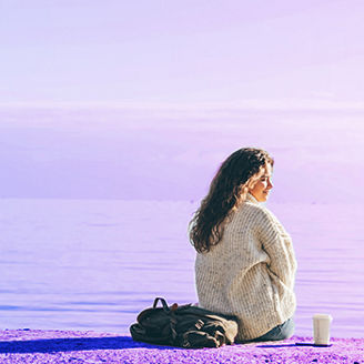 Woman sitting in front of the sea
