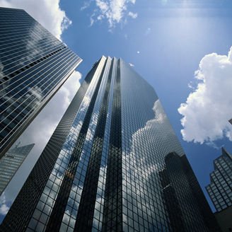 Office buildings reflecting clouds, low angle view