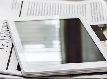 Tablet and newspaper