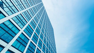 Tall building blue windows against sky