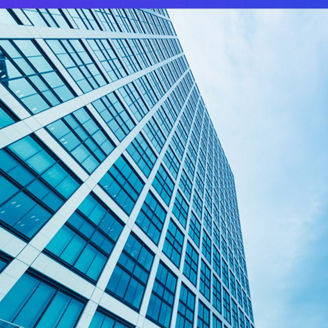 Tall building blue windows against sky