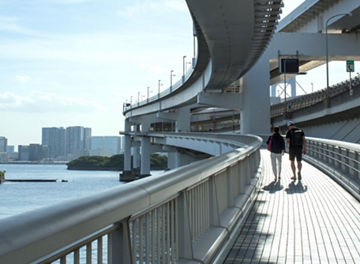 Two people walking on a bridge