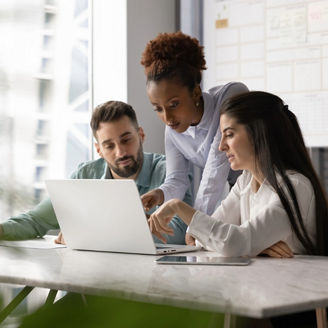Team discussing on laptop
