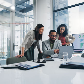 Team discussing work on laptop